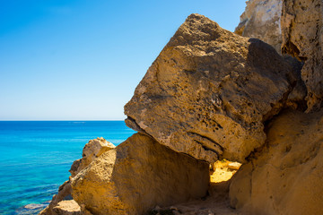  colorful pristine nature of the coast of Cyprus cape cavo greco with clear blue water and yellow rocks