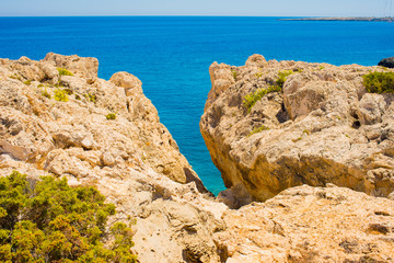  colorful pristine nature of the coast of Cyprus cape cavo greco with clear blue water and yellow rocks