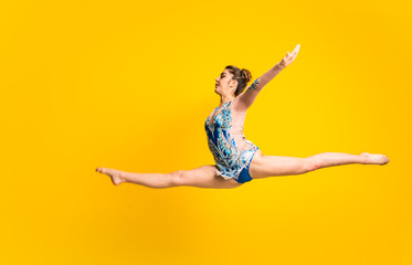 Girl doing rhythmic gymnastics jumping