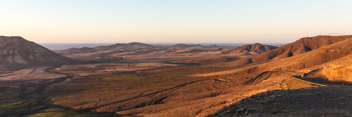 Fototapeta na wymiar Panorama. Sunset in the mountains of Fuerteventura. Canary Islands. Spain