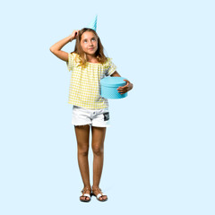 Full body of Little girl at a birthday party holding a gift standing and thinking an idea on blue background