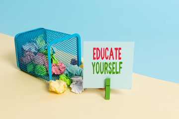 Text sign showing Educate Yourself. Business photo showcasing prepare oneself or someone in a particular area or subject Trash bin crumpled paper clothespin empty reminder office supplies tipped