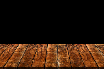 Empty wooden table isolated on black background