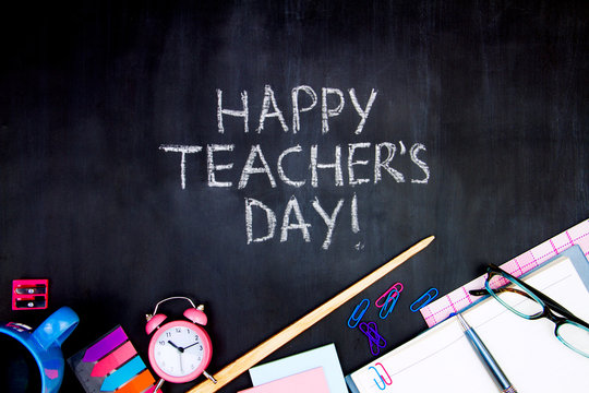 Back to school, college, university concept. Congratulatory inscription of happy teacher's day on blackboard background from pupils. Office supplies, pointer, glasses, notebook are scattered on canvas - Powered by Adobe