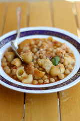 Plate of pasta, chickpea and shrimp stew. Selective focus.