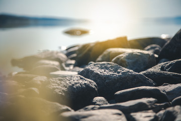 Stones on the shore of the lake, details of nature, soft focus, beautiful landscape