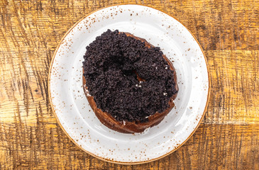 curd ring with poppy seeds on a white plate, top view