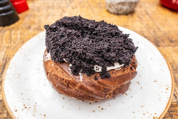 curd ring with poppy seeds on a white plate, top view