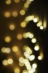 Defocused background of Christmas lights outdoors. Blurred lights background.