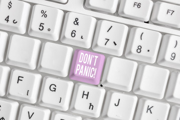 Word writing text Don T Panic. Business photo showcasing suddenly feel so worried or frightened that you can not behave White pc keyboard with empty note paper above white background key copy space