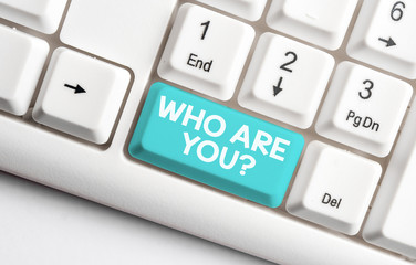 Conceptual hand writing showing Who Are You Question. Concept meaning asking about someone identity or demonstratingal information White pc keyboard with note paper above the white background