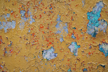 Painted wall with peeling paint. Texture wall covering, background. Outer wall on the street.