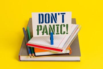 Writing note showing Don T Panic. Business concept for suddenly feel so worried or frightened that you can not behave Book pencil rectangle shaped reminder notebook clothespins