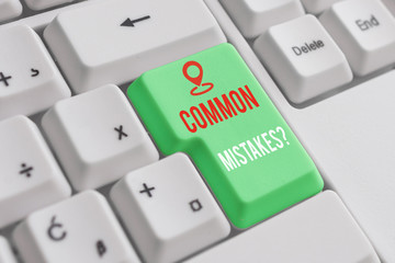 Text sign showing Common Mistakes Question. Business photo showcasing repeat act or judgement misguided making something wrong White pc keyboard with empty note paper above white background key copy