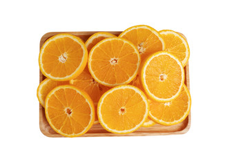 Orange fruits sliced into pieces on the wooden plate with isolated white backgrounds