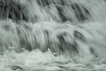 Waterfall background. rushing stream water abstract backdrop