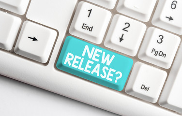 Conceptual hand writing showing New Release Question. Concept meaning asking about recent product or service newly unleashed White pc keyboard with note paper above the white background