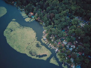 Fishing village on the beach. Sea village on cloudy sky. Houses on mountain landscape with nice architecture. Summer vacation on mediterranean island. Wanderlust and travelling.