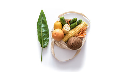 Grocery shopping with eco bag over white background. Zero waste and plastic free concept. Flat lay. Copy space.