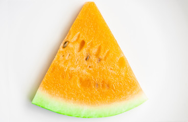 Sliced yellow watermelon on the white plate.