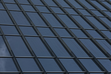 Fototapeta premium Angular view of glass building wall