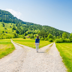 A choice of two ways. Woman at a crossroads.