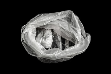 White transparent plastic bag on a black background. Environmental pollution from the use of...
