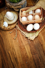 Organic chicken eggs in egg box against old style wooden background