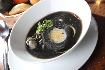 Black stuffing soup with hard-boiled egg and cilantro. This dish is typical of the Yucatan peninsula.