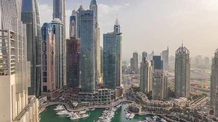 Aerial top view of Dubai Marina morning timelapse. Modern towers and traffic on the road