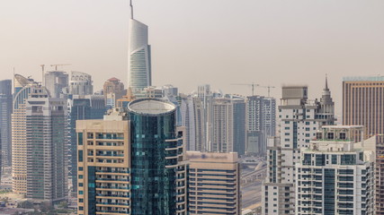 Naklejka premium Aerial top view of Dubai Marina morning timelapse. Modern towers and traffic on the road