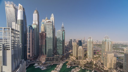 Fototapeta na wymiar Aerial top view of Dubai Marina evening timelapse. Modern towers and traffic on the road