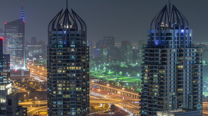 Fototapeta na wymiar Aerial top view of Dubai Marina night timelapse. Modern towers and traffic on the road