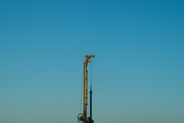 Fototapeta premium Industrial construction building crane city against a blue sky