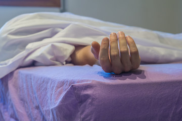 Dead man in bed covered with a White blanket