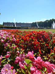 Historic castle in the wonderful blooming gardens with fountains