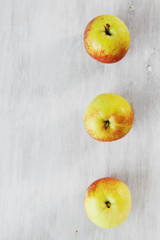Three apples on a wooden background with copy space
