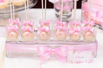 Stylish cake pops on a candy bar at the wedding party
