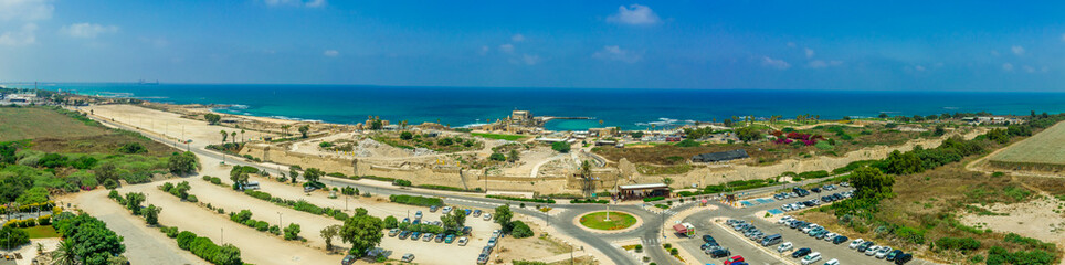 Fototapeta premium Aerial panoramic view of the ruins of the Roman, Byzantine, Crusader era fortified town in Caesarea Maritima built originally by Herod the Great in Israel 