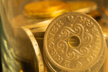 Coins of the various countries in a glass jar. metal coins of different denominations. finance background