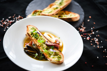 tasty seafood soup with fresh vegetables - shrimps, shells, octopus and crispy home made bread