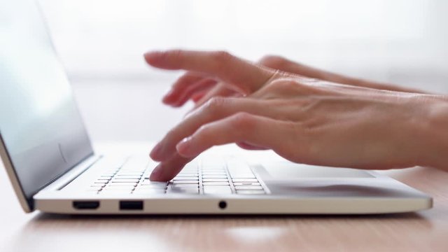 Woman freelancer working on laptop at home-office. Close up of female hands typing on keyboard. Businesswoman writing business letter at work. Dolly shot