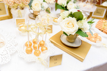 Golden cake pops on a elegant wedding candy bar