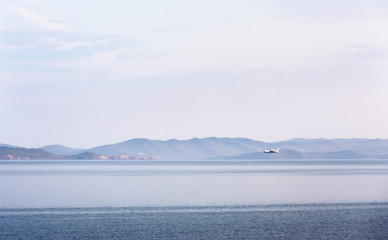 Amphibian aircraft during refueling by water to extinguish forest fires in Irkutsk Region. Lake Baikal, Small Sea Strait