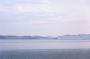 Amphibian aircraft during refueling by water to extinguish forest fires in Irkutsk Region. Lake Baikal, Small Sea Strait