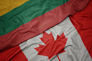 waving colorful flag of canada and national flag of lithuania.