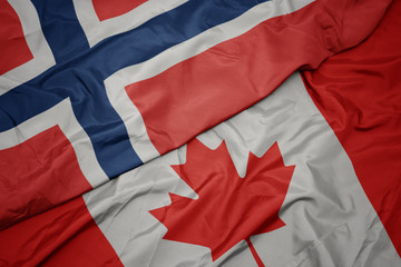 waving colorful flag of canada and national flag of norway.