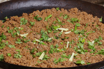 beef keema special spicy curry garnished with coriander leaves and ginger.