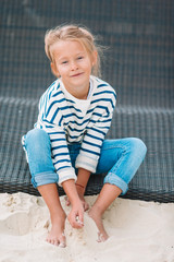 Fototapeta premium Beautiful little girl at beach having fun. Funny girl enjoy summer vacation.