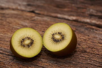 Tasty kiwi fruit on wooden background